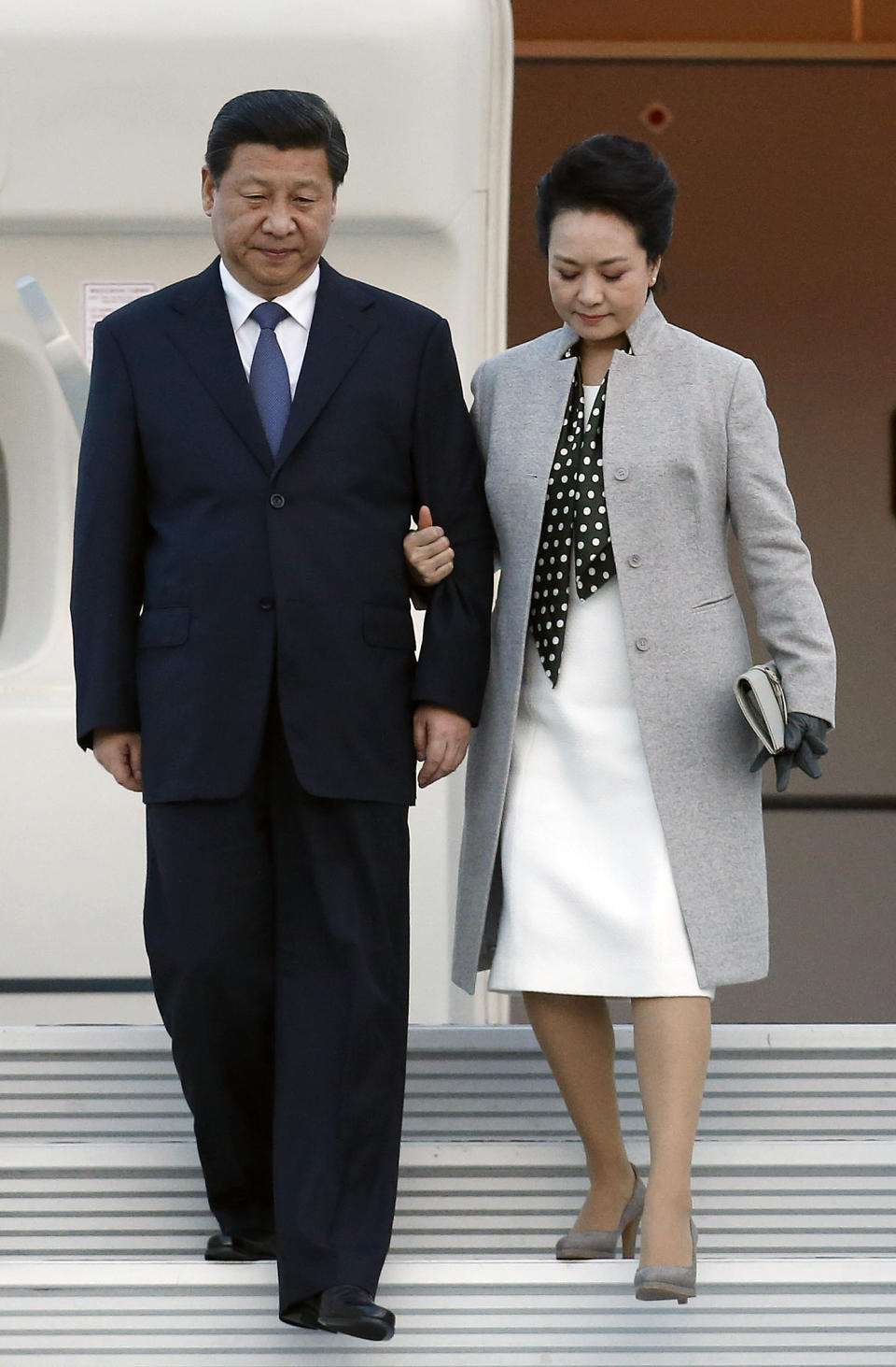 Chinese President Xi Jinping and his wife Peng Liyuan arrive at Lyon airport, central France, Tuesday, March 25, 2014. Xi will later have a dinner at the Lyon town-hall and has arrived in France for a three-day state visit. (AP Photo/Str)
