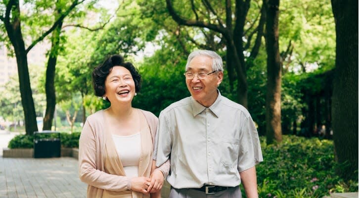 Asian couple taking a walk outside.