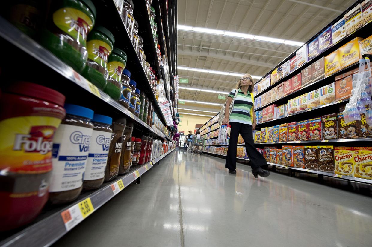 A customer walks down the coffee and breakfast cereal aisle on the opening day of the new Walmart Neighborhood Market in Panorama City, California, a working class area about 13 miles (20km) northwest of Los Angeles, on September 28, 2012.  Smaller than Walmart's SuperCenter, the Neighborhood Market resembles a traditional supermarket, selling food, health and beauty products and home cleaning supplies.    AFP PHOTO / Robyn Beck        (Photo credit should read ROBYN BECK/AFP/GettyImages)