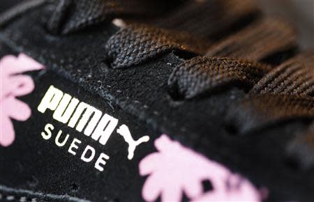 The logo of German sports goods firm Puma is seen on a shoe after the company's annual news conference in Herzogenaurach February 20, 2014. REUTERS/Michaela Rehle