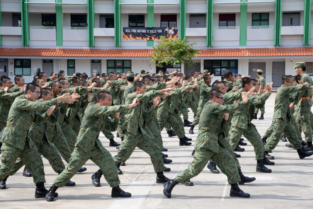 National Service recruits demonstrate hand-to-hand combat moves as part of their two-month long basic training on Pulau Tekong off Singapore on February 7, 2017.  Singapore will keep its mandatory military service because it cannot depend on help from others in an uncertain world, the city-state's defence minister said February 7. / AFP / TOH TING WEI        (Photo credit should read TOH TING WEI/AFP via Getty Images)