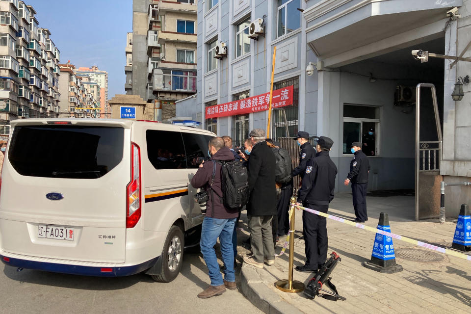 Journalists surround a police van as it arrives at a court building in Dandong in northeastern China's Liaoning Province, Friday, March 19, 2021. China was expected to open the first trial Friday for Michael Spavor, one of two Canadians who have been held for more than two years in apparent retaliation for Canada's arrest of a senior Chinese telecom executive. (AP Photo/Ken Moritsugu)