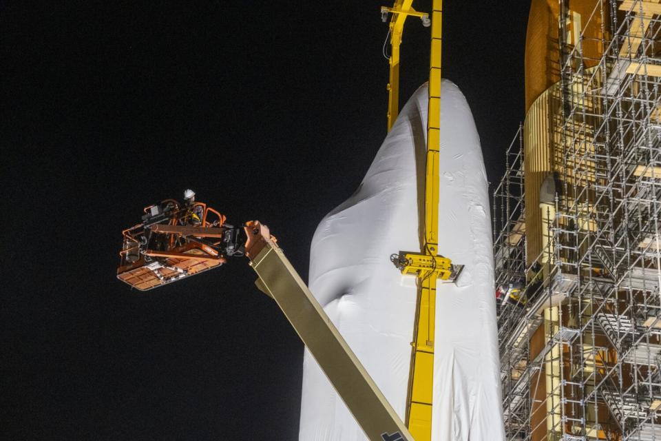 Crew members inspect the space shuttle Endeavour.