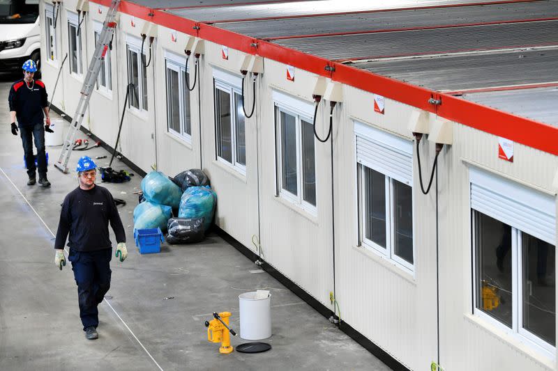 Workers build units inside the concert hall Ahoy in Rotterdam