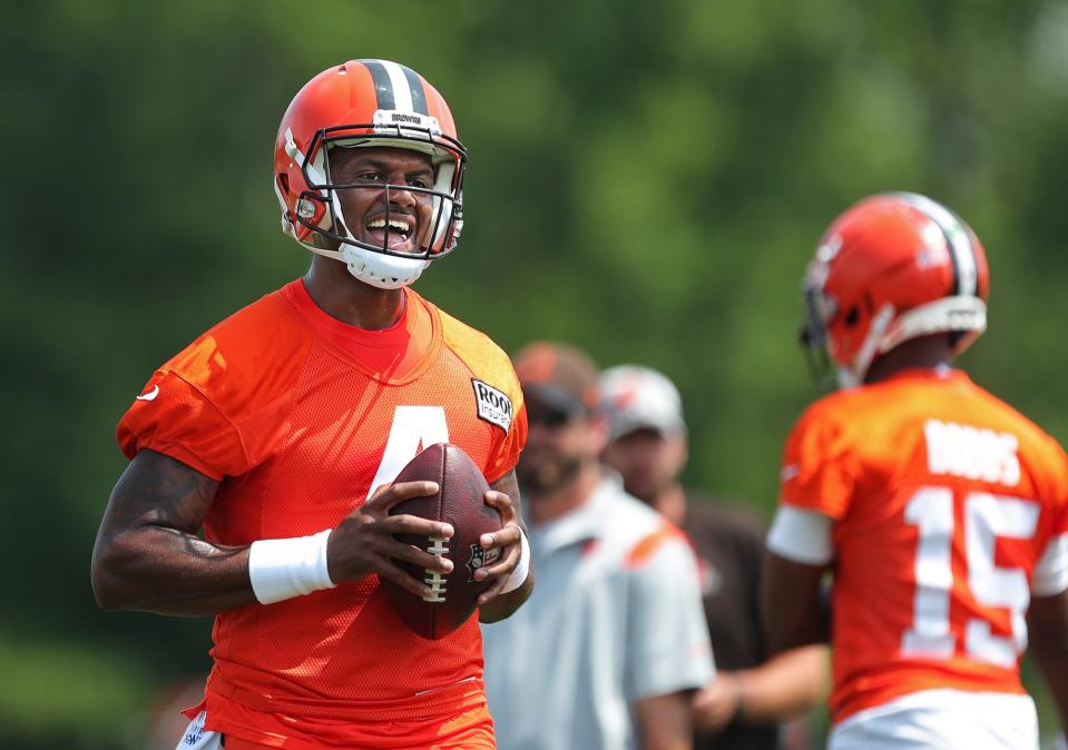 Cleveland Browns quarterback Deshaun Watson, left, is all smiles as he participates in drills during the NFL football team's football training camp in Berea on Monday.