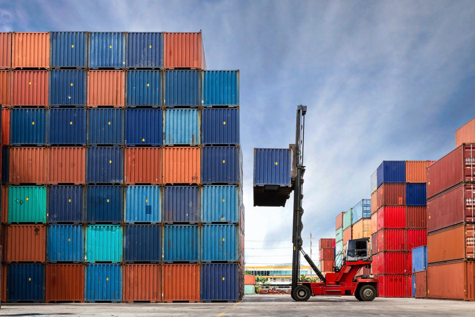 forklift in a shipping container lot