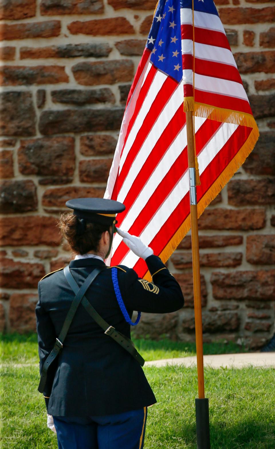 Master Sgt. Rebecca McGary, the non-commissioned officer in charge of the Governor's Honor Guard, salutes during the retiring of the colors at the annual Memorial Day ceremony at the 45th Infantry Division Museum in Oklahoma City, Monday, May 27, 2019.