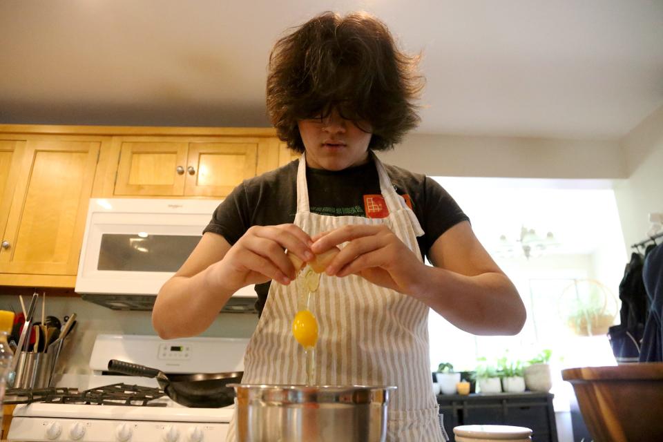 Alex Doane prepares an egg dish with fresh eggs for breakfast at his Exeter home on Friday, July 15, 2022.