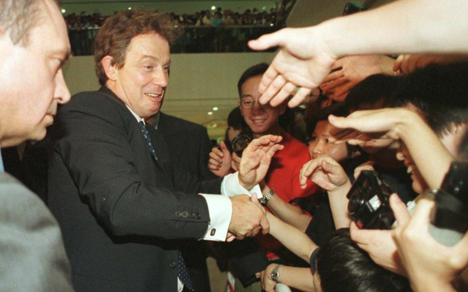 Tony Blair greets a crowd gathered at Pacific Place, as he toured the shopping centre in Hong Kong - Anat Givon