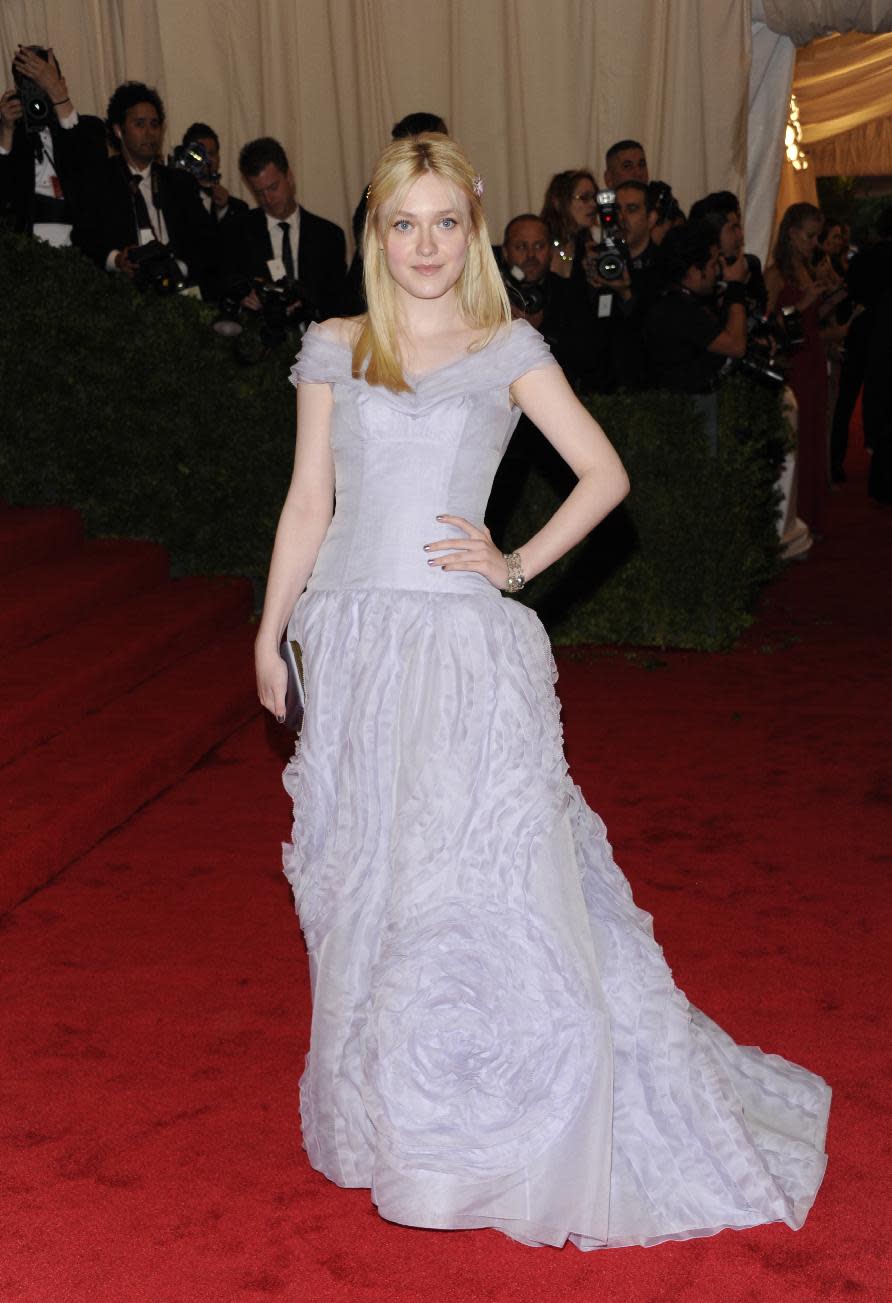 Dakota Fanning arrives at the Metropolitan Museum of Art Costume Institute gala benefit, celebrating Elsa Schiaparelli and Miuccia Prada, Monday, May 7, 2012 in New York. (AP Photo/Evan Agostini)