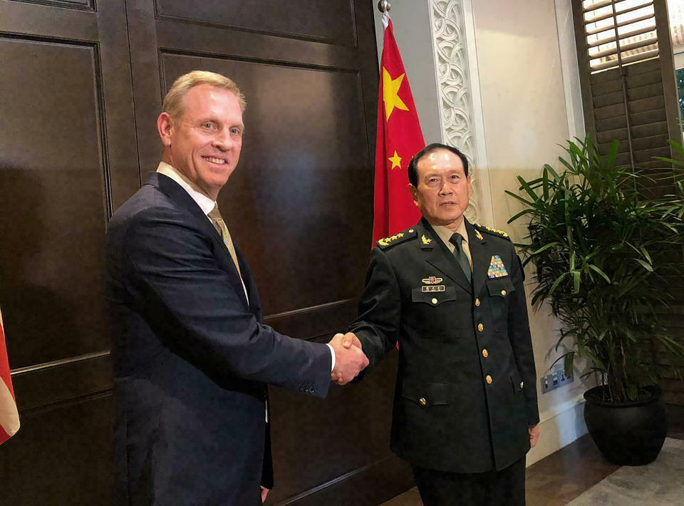 FILE - In this May 31, 2019, file photo, acting U.S. Secretary of Defense Patrick Shanahan, left, shakes hands with Chinese Minister of National Defense Wei Fenghe during a meeting on the sidelines of the 18th International Institute for Strategic Studies (IISS) Shangri-la Dialogue, in Asia, in Singapore. U.S. Acting Defense Secretary Shanahan denounced China's efforts to militarize man-made outposts in the South China Sea as part of a "toolkit of coercion," saying activities by Beijing the U.S. perceives as hostile must end. (AP Photo/Lolita Baldor, File)