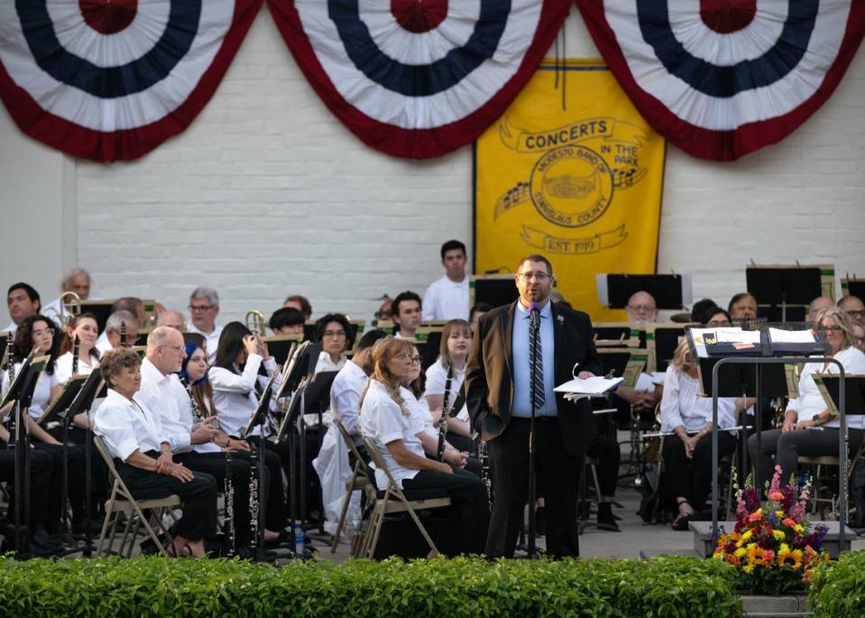 MoBand assistant conductor, Brad Hart addresses the crowd during the first concert of the season for Modesto Band of Stanislaus County at Mancini Bowl in Graceada Park in Modesto, Calif., Thursday, June 8, 2023.