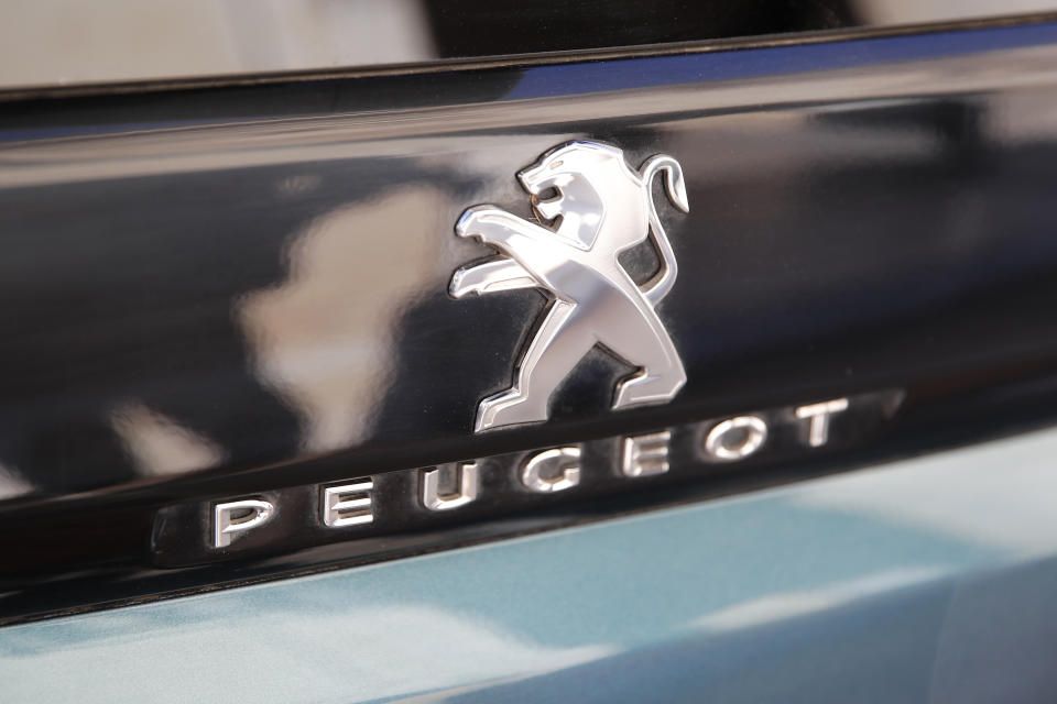 The logo of the French car maker Peugeot is pictured Wednesday, Dec.18, 2019 in Paris. The boards of Fiat Chrysler Automobiles and PSA Peugeot on Wednesday signed a binding merger deal creating the world's fourth-largest automaker with the scale to confront the challenges of stricter emissions regulations and the transition to new driving technologies. (AP Photo/Francois Mori)