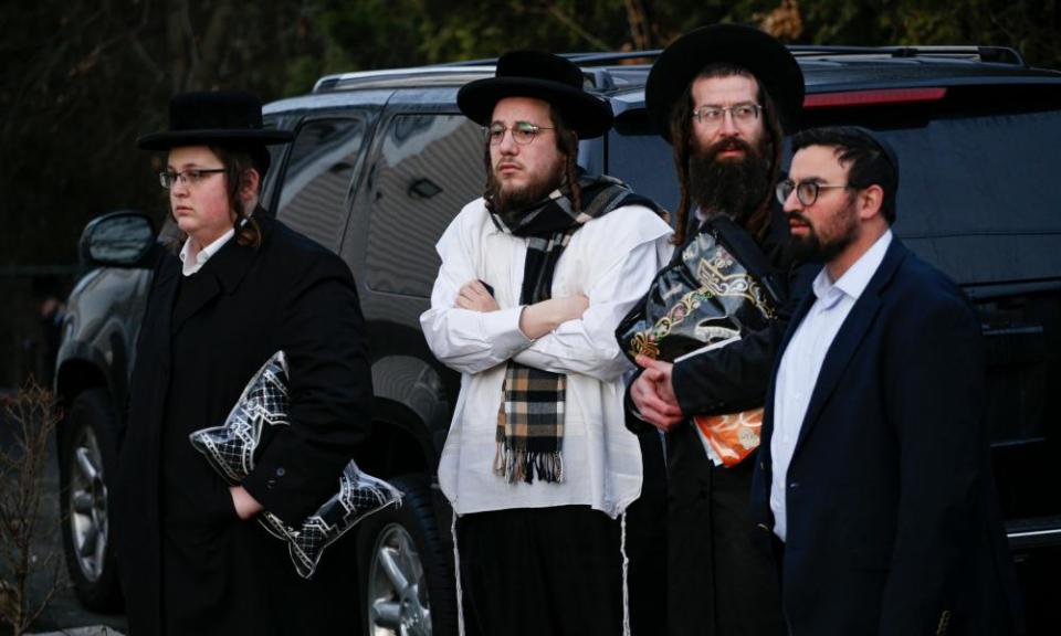 Members of the Jewish community gather outside the home of rabbi in Rockland county on Sunday.