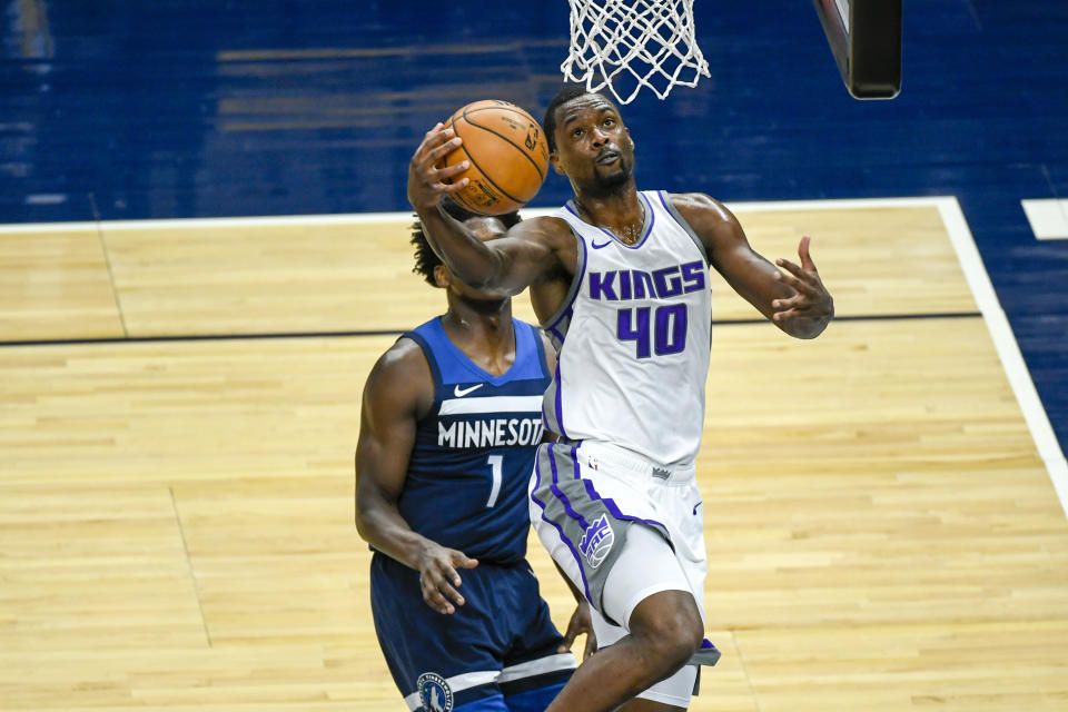 Sacramento Kings forward Harrison Barnes goes up to shoot past Minnesota Timberwolves guard Anthony Edwards during the first half of an NBA basketball game Monday, April 5, 2021, in Minneapolis. (AP Photo/Craig Lassig)