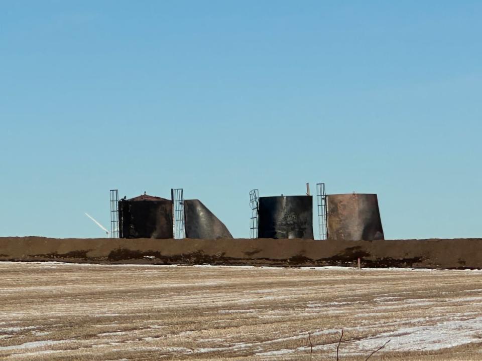 Four crude oil tanks caught fire at this oil lease site east of Edmonton on Tuesday afternoon, triggering an emergency alert for surrounding communities due to concerns about toxic smoke. 