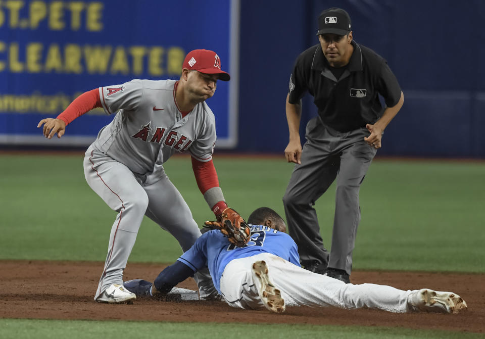 Umpire Gabe Morales, right, watches as Tampa Bay Rays' Manuel Margot (13) beats the tag from Los Angeles Angels shortstop Jose Iglesias, left, to steal second base during the first inning of a baseball game Friday, June 25, 2021, in St. Petersburg, Fla. (AP Photo/Steve Nesius)