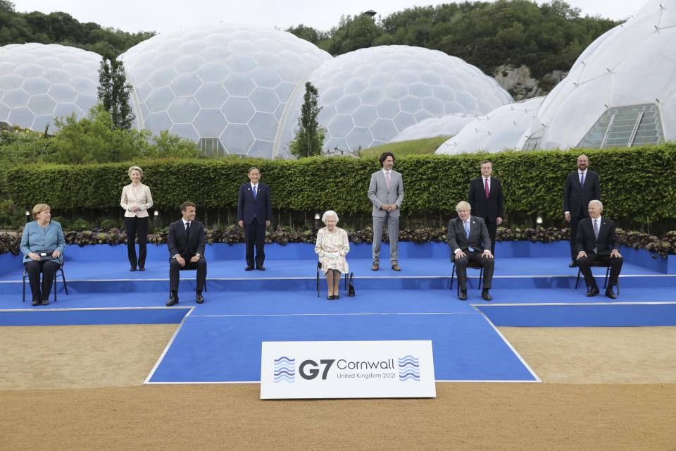 Britain's Queen Elizabeth II poses for a group photo with G7 leaders, from left, back row, President of the European Commission Ursula von der Leyen, Japan's Prime Minister Yoshihide Suga, Canada's Prime Minister Justin Trudeau, Italy's Prime Minister Mario Draghi and President of the European Council Charles Michel, from left, front row, German Chancellor Angela Merkel, French President Emmanuel Macron, Britain's Prime Minister Boris Johnson and US President Joe Biden before a reception at the Eden Project in Cornwall, England, Friday June 11, 2021, during the G7 summit. (Jack Hill/Pool via AP)