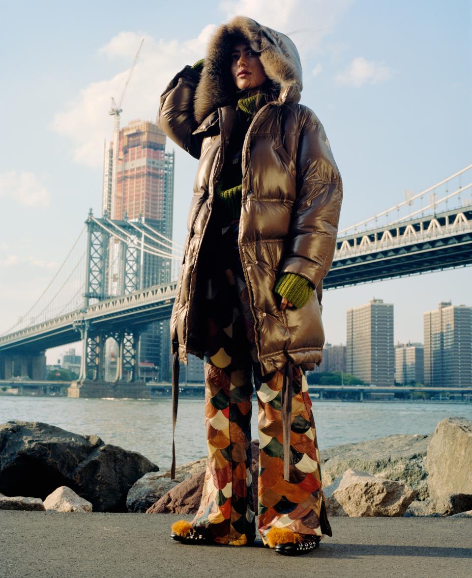 Nepalese jewelry designer Arpana Rayamajhi heads out to Dumbo to take in the Manhattan skyline in a <a rel="nofollow noopener" href="https://weallwear.moncler.com/" target="_blank" data-ylk="slk:Moncler Escallonia coat;elm:context_link;itc:0;sec:content-canvas" class="link ">Moncler Escallonia coat</a>, $2,300.