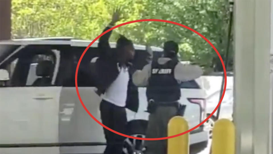 Chiefs defensive back Bashaud Breeland raising his hands as he is arrested at gun point.