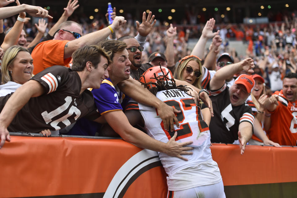 Cleveland Browns running back Kareem Hunt (27) is mobbed by fans after he scored a 29-yard touchdown during the second half of an NFL football game against the Chicago Bears, Sunday, Sept. 26, 2021, in Cleveland. (AP Photo/David Richard)