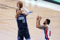 Dallas Mavericks guard Jalen Brunson (13) shoots over Detroit Pistons guard Cory Joseph during the first half of an NBA basketball game in Dallas, Wednesday, April 21, 2021. (AP Photo/Tony Gutierrez)