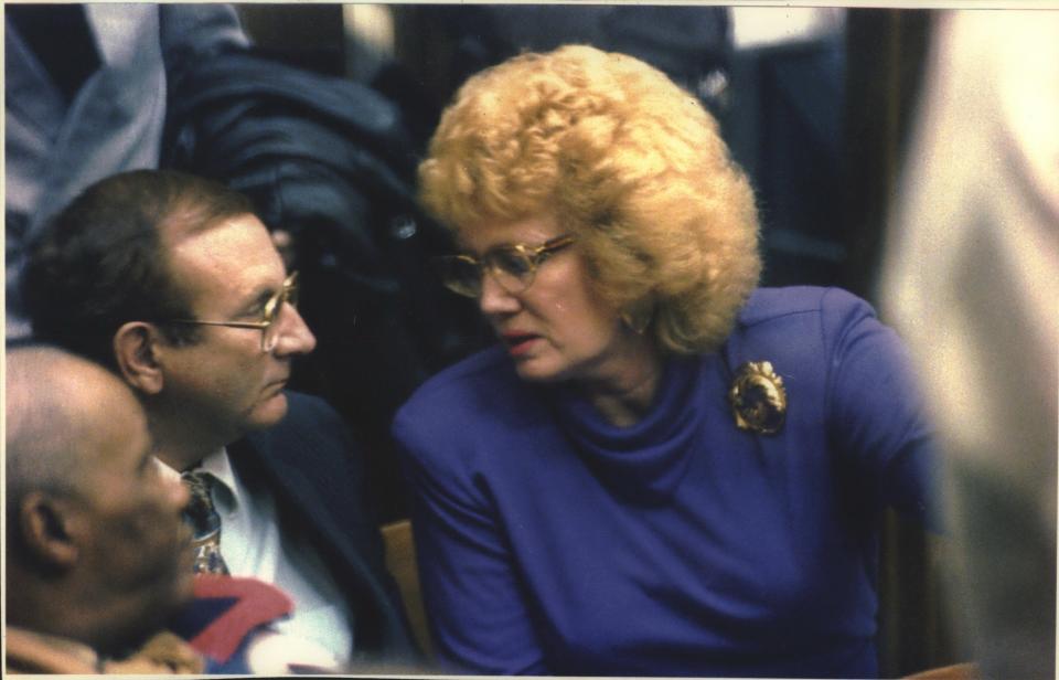 Lionel Dahmer, father of serial killer Jeffrey L. Dahmer, talks with his wife, Shari, during first day of testimony in Dahmer's sanity trial.