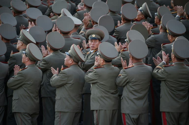 Soldiers applaud the arrival North Korean leader Kim Jong-Un during a mass military parade at Kim Il-Sung square in Pyongyang in October 2015