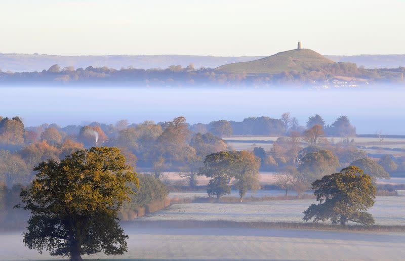 FILE PHOTO: Glastonbury Tor is seen through early morning mist at Glastonbury