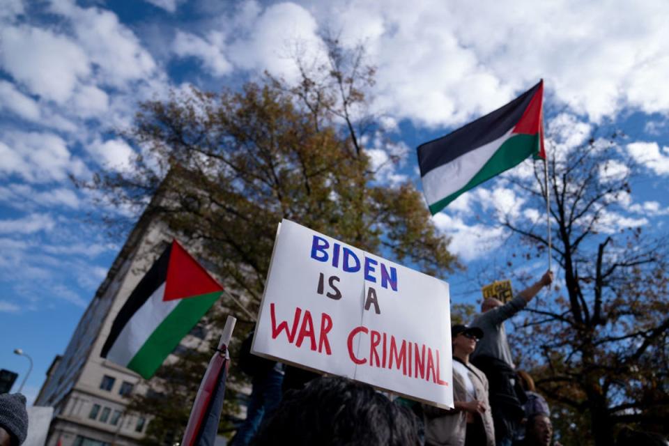 A person holds up a sign denouncing Joe Biden at Saturday’s March for Palestine in Washington (AFP via Getty Images)