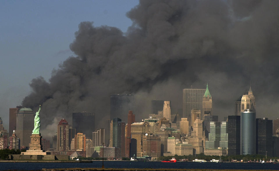 FILE -- In this Sept. 11, 2001 file photo, thick smoke billows into the sky from the area behind the Statue of Liberty, lower left, where the World Trade Center towers stood. The kingdom of Saudi Arabia has enjoyed the ultimate protected status from the U.S. throughout its short history. Fifteen of the 19 Sept. 11 hijackers were Saudi citizens and much has been said of the Bush administration’s decision to apportion no blame to the kingdom. The uncomfortable truth that Wahhabism, the ultraconservative Islamic doctrine Saudi Arabia follows, has been linked to extremists at home and overseas has been carefully navigated by Washington and Riyadh. (AP Photo/Daniel Hulshizer, File)