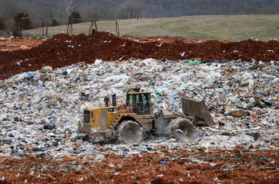 A landfill compactor drives over trash, compressing it down, at the Springfield Noble Hill Sanitary Landfill in Willard on Thursday, March 2, 2023.