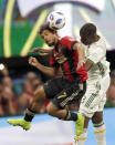 Atlanta United forward Josef Martinez (7) heads the ball against Portland Timbers defender Larrys Mabiala (33) during the first half of the MLS Cup championship soccer game, Saturday, Dec. 8, 2018, in Atlanta. (AP Photo/John Bazemore)