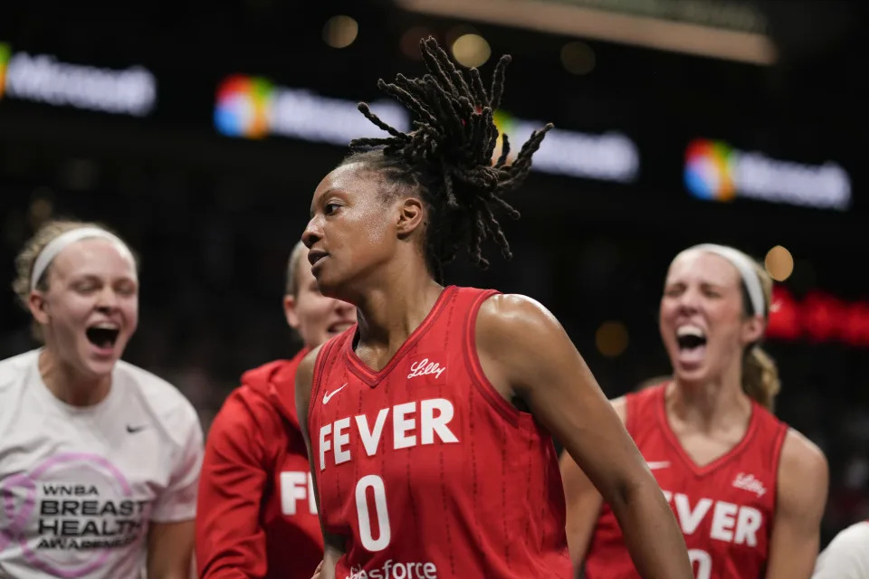 Indiana Fever team reacts to Kelsey Mitchell (0) in the first half of an WNBA basketball game against the Atlanta Dream, Monday, Aug. 26, 2024, in Atlanta. (AP Photo/Brynn Anderson)