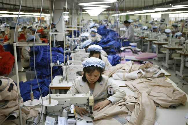 North Korean workers assemble jackets at a factory of a South Korean-owned company at the jointly-run Kaesong Industrial Complex, in Kaesong, North Korea, Thursday, Dec. 19, 2013. The Kaesong complex just north of the border is the last remaining inter-Korean rapprochement project. Its operations halted in April when Pyongyang withdrew its workers amid tension over North Korean threats of nuclear war. It reopened in September after North Korea toned down its rhetoric and began pursuing diplomacy with South Korea. (AP Photo/Kim Hong-Ji, Pool)