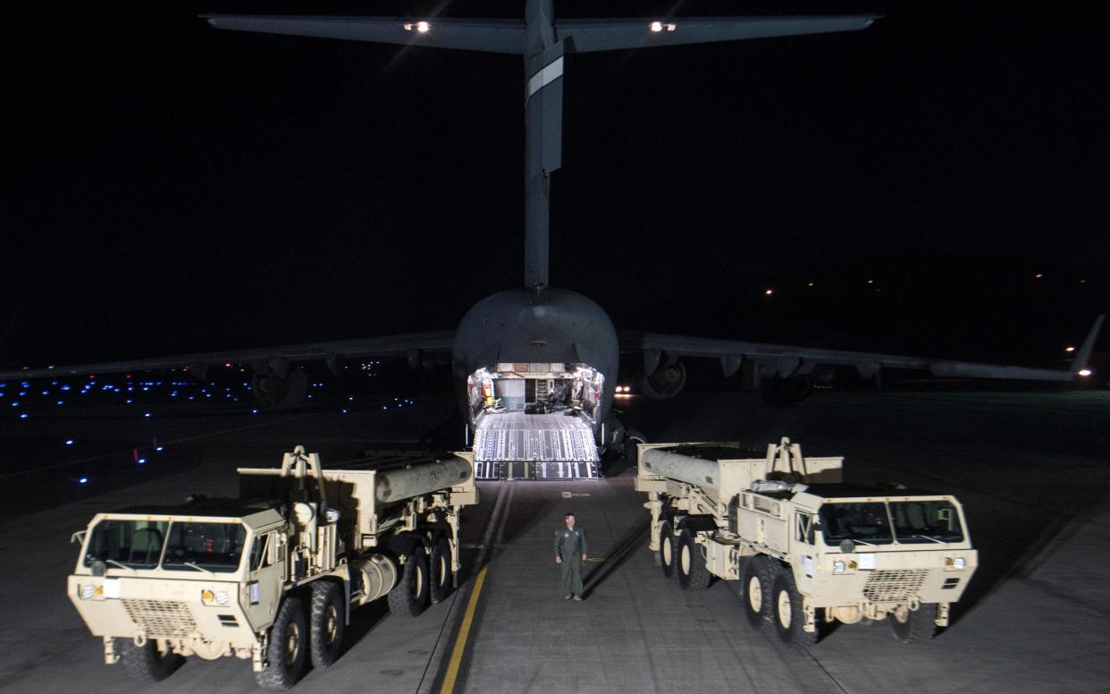 Trucks carrying parts of US missile launchers and other equipment needed to set up the THAAD missile defence system arrive at Osan air base - AP