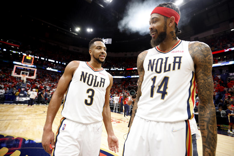 NEW ORLEANS, LOUISIANA - APRIL 13: CJ McCollum #3 of the New Orleans Pelicans and Brandon Ingram #14 of the New Orleans Pelicans react after their team defeated the San Antonio Spurs 113 - 103 after the 2022 NBA Play-In Tournament at Smoothie King Center on April 13, 2022 in New Orleans, Louisiana. NOTE TO USER: User expressly acknowledges and agrees that, by downloading and or using this photograph, User is consenting to the terms and conditions of the Getty Images License Agreement. (Photo by Sean Gardner/Getty Images)