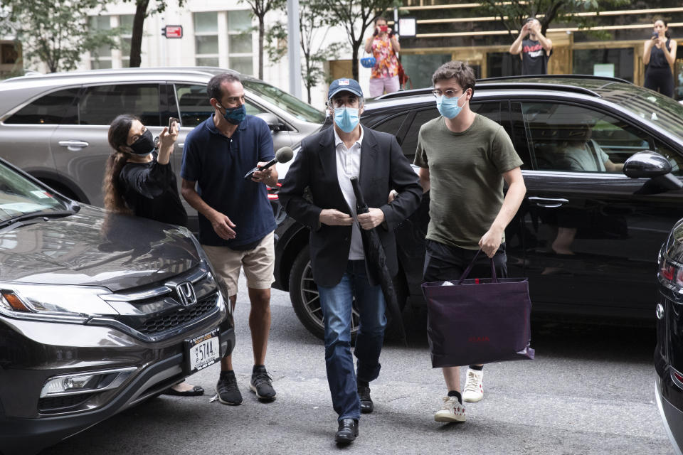 Michael Cohen, President Donald Trump's former personal attorney, returns to his apartment after being released from prison, Friday, July 24, 2020, in New York. District Judge Alvin Hellerstein ordered Cohen released on parole saying he believes the government retaliated against him for writing a book about Trump. (AP Photo/Mark Lennihan)