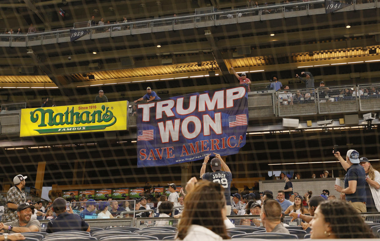 Fans unroll a banner in support of former U.S. President Donald Trump during the fourth inning of Game Two of a doubleheader between the Toronto Blue Jays and the New York Yankees at Yankee Stadium on May 27, 2021 in the Bronx borough of New York City. (Sarah Stier/Getty Images)