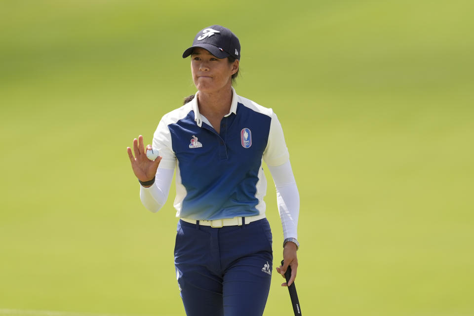 Celine Boutier, of France, acknowledges the crowd after making birdie putt on the 10th green during the first round of the women's golf event at the 2024 Summer Olympics, Wednesday, Aug. 7, 2024, at Le Golf National, in Saint-Quentin-en-Yvelines, France. (AP Photo/George Walker IV)