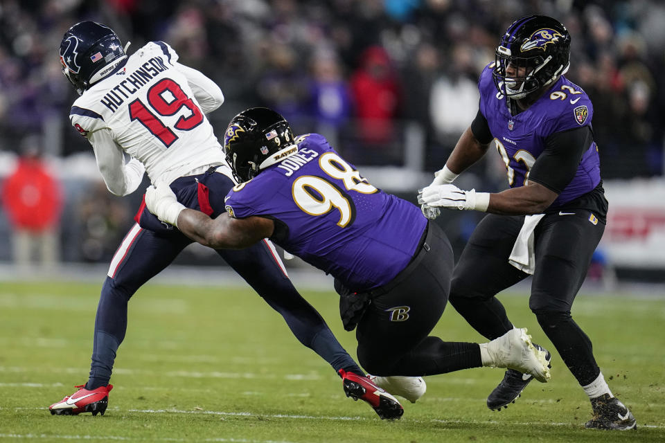 Baltimore Ravens defensive tackle Travis Jones (98) tackles Houston Texans wide receiver Xavier Hutchinson (19) during the first half of an NFL football AFC divisional playoff game, Saturday, Jan. 20, 2024, in Baltimore. (AP Photo/Julio Cortez)