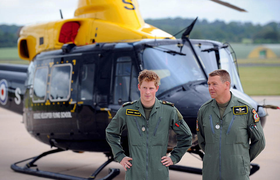 Britain's Prince Harry (L) and his instructor arrive for a photocall at RAF (Royal Air Force) Shawbury near Shrewsbury, central England, on June 18, 2009. Both princes are stationed at the Defence Helicopter Flying School training to fly helicopters. William is training to become an RAF search and rescue pilot while his younger brother Harry is aiming to become a pilot with Britain's Army Air Corps. AFP PHOTO/PAUL ELLIS (Photo credit should read PAUL ELLIS/AFP via Getty Images)