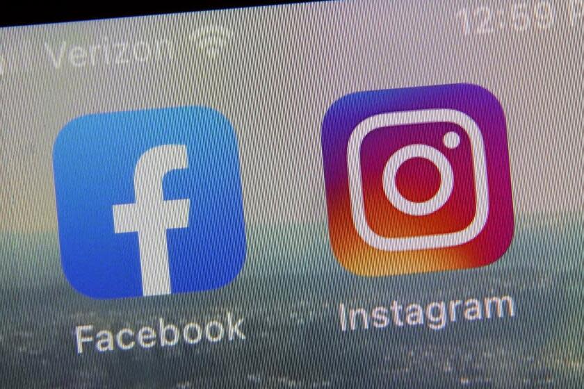 FILE - This photo shows the mobile phone app logos for, from left, Facebook and Instagram in New York, Oct. 5, 2021. A team of some of the world's leading social media researchers has published four studies looking at the relationship between the algorithms used by Facebook and Instagram and America's widening political divide. (AP Photo/Richard Drew, file)