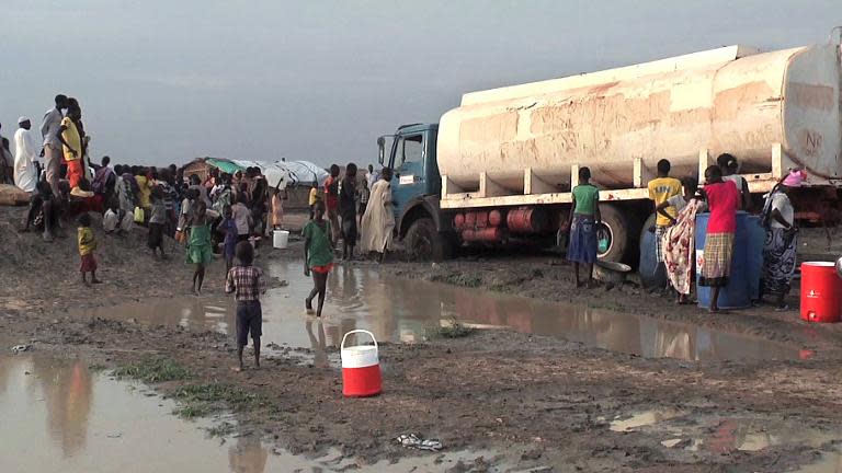 A video grab released by the United Nations Mission in South Sudan (UNMISS) on April 23, 2014 shows displaced people gathering water at a camp in Bentiu, on April 22, 2014