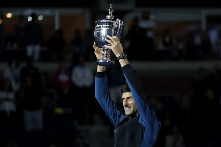 Sep 9, 2018; New York, NY, USA; Novak Djokovic of Serbia celebrates with the championship trophy after his match against Juan Mart’n Del Potro of Argentina (not pictured) in the men's final on day fourteen of the 2018 U.S. Open tennis tournament at USTA Billie Jean King National Tennis Center. Mandatory Credit: Geoff Burke-USA TODAY Sports