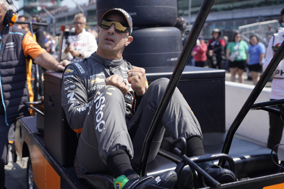 Tony Kanaan, of Brazil, reacts as Alexander Rossi qualifies for the Indianapolis 500 auto race at Indianapolis Motor Speedway, Saturday, May 20, 2023, in Indianapolis. (AP Photo/Darron Cummings)