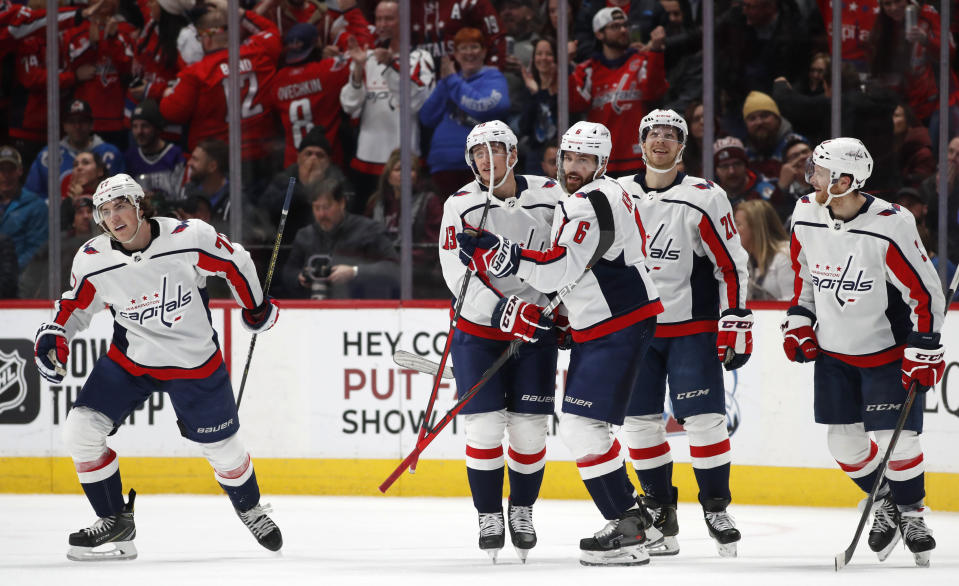 Washington Capitals right wing T.J. Oshie, left, skates away as left wing Jakub Vrana, defenseman Michal Kempny, center Lars Eller and defenseman Nick Jensen, from second from left, celebrate after Oshie scored the go-ahead goal against the Colorado Avalanche during the third period of an NHL hockey game Thursday, Feb. 13, 2020, in Denver. Jensen and Eller had assists on the goal. The Capitals won 3-2. (AP Photo/David Zalubowski)