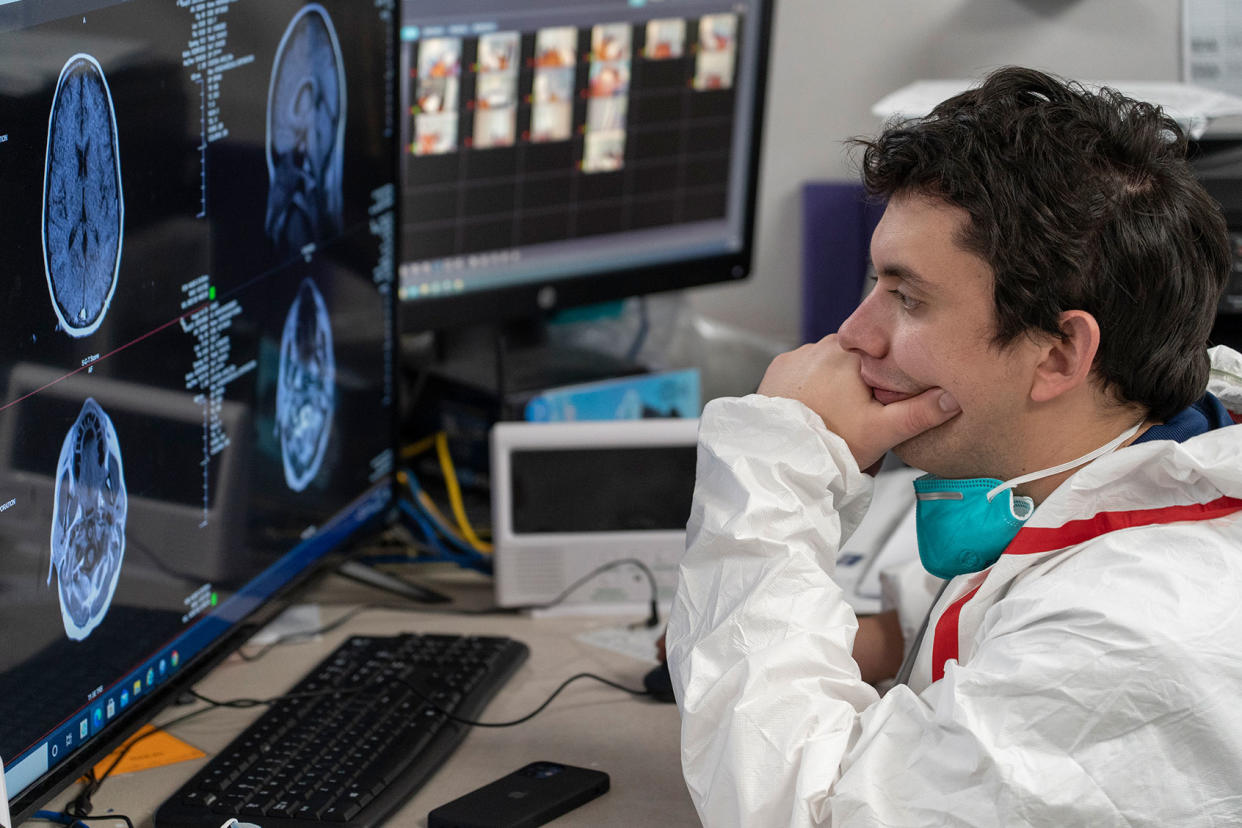 Doctor looking at MRI scans of COVID Patient Go Nakamura/Getty Images