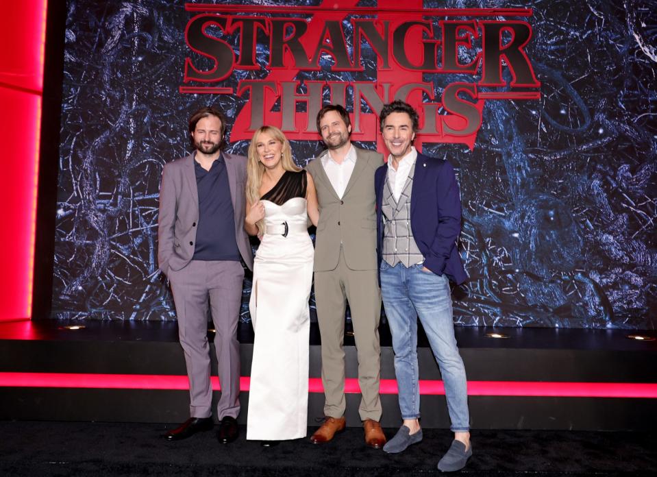 <p>Matt Duffer, Millie Bobby Brown, Ross Duffer and Shawn Levy pose together at the premiere of <em>Stranger Things </em>season 4 in Brooklyn on May 14.</p>