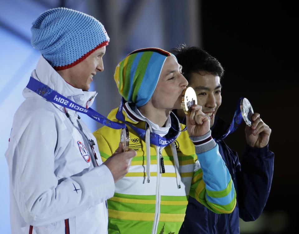 Medal winners in the men's normal hill nordic combined, from left, Norway's Magnus Krog, bronze, Germany's Eric Frenzel, gold, and Japan's Akito Watabe, silver, pose with their medals at the 2014 Winter Olympics in Sochi, Russia, Thursday, Feb. 13, 2014. (AP Photo/Morry Gash)